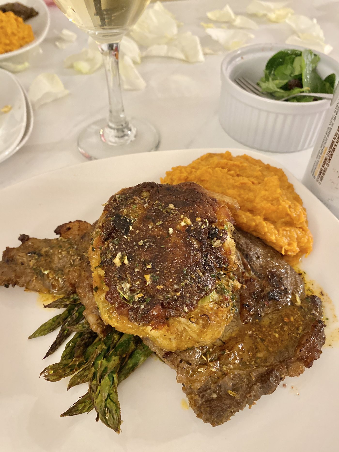 Steak topped with crab cake and sweet potato